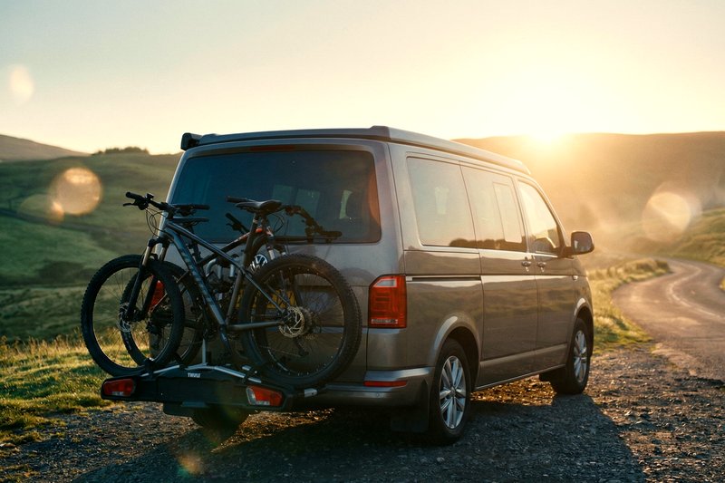 Towbar-mounted bike rack on a VW T6 campervan