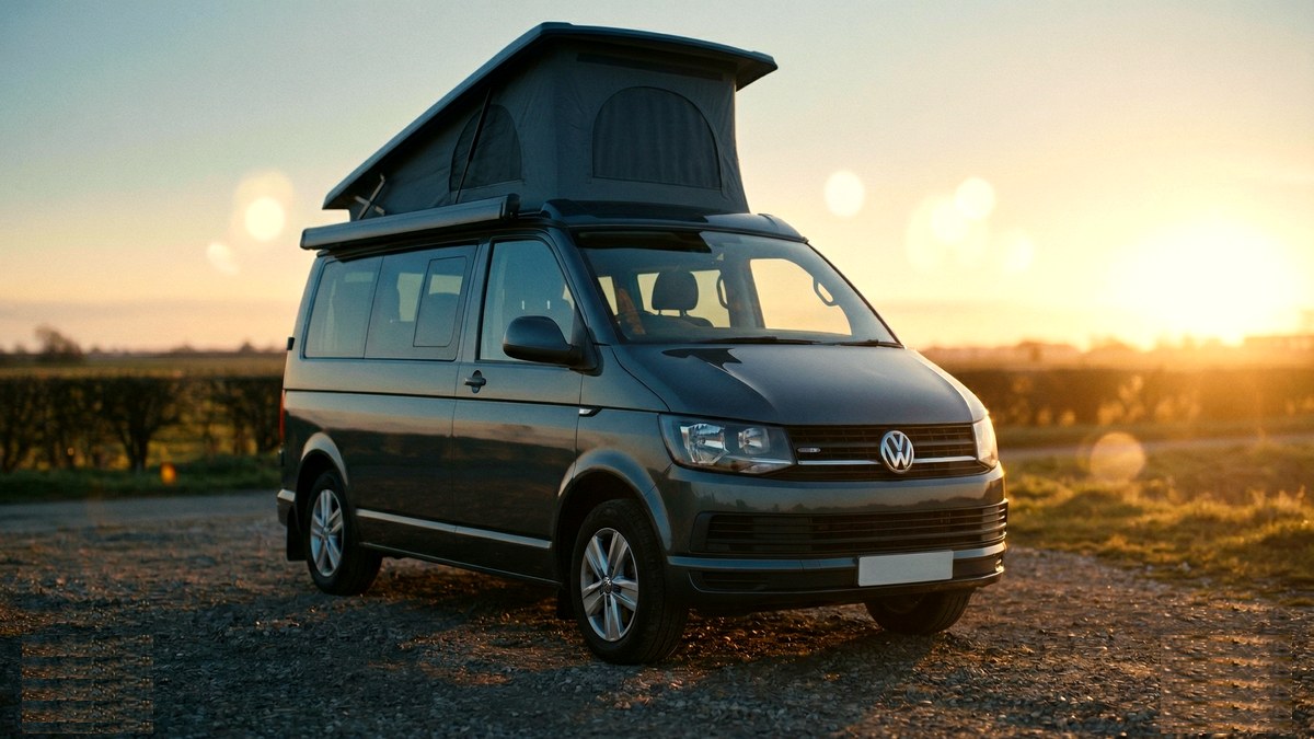 VW T6 campervan pitched on a campsite with awning